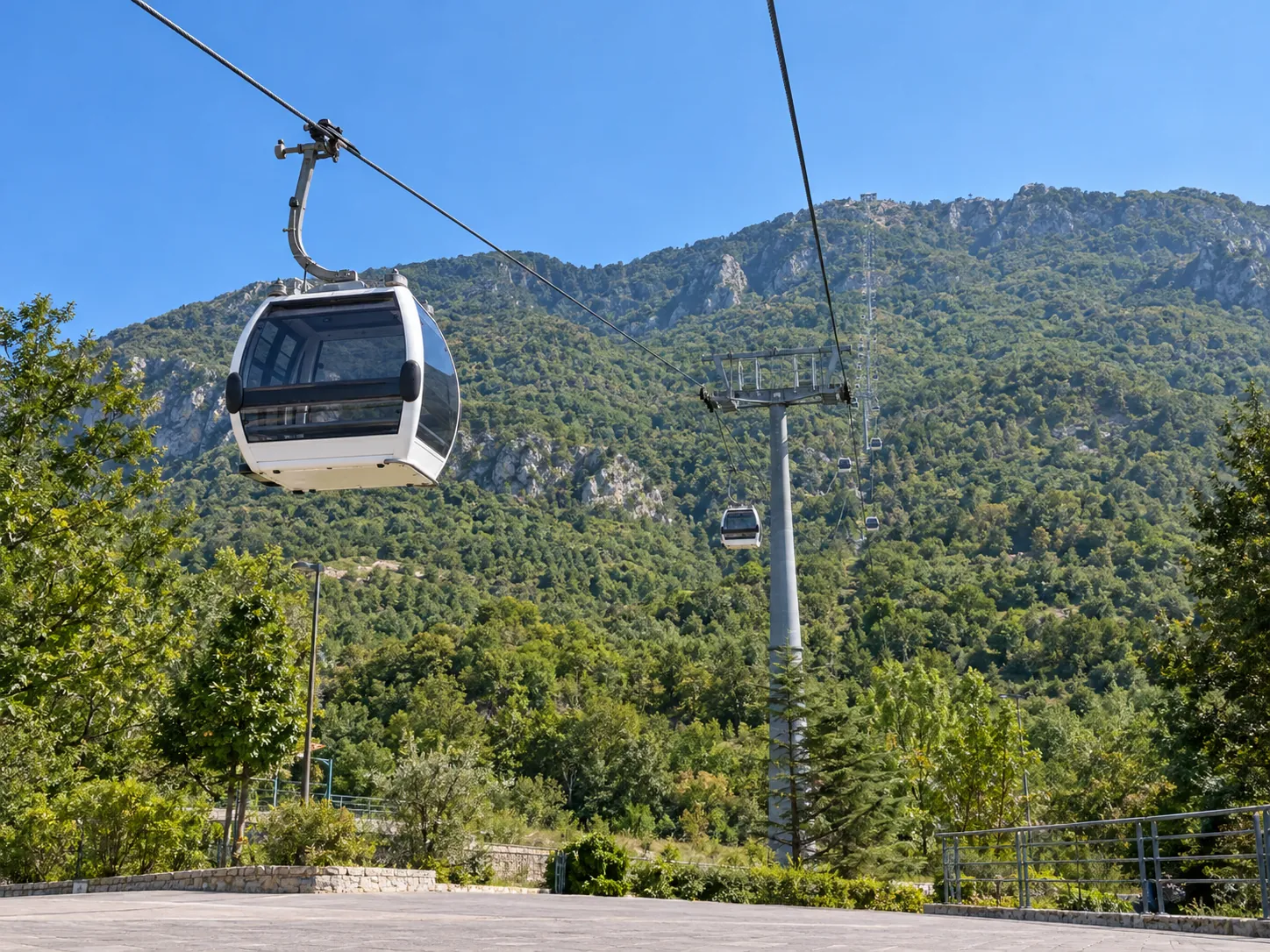 White Dajti Ekspres gondola above the green foothills of Mount Dajti near Tirana